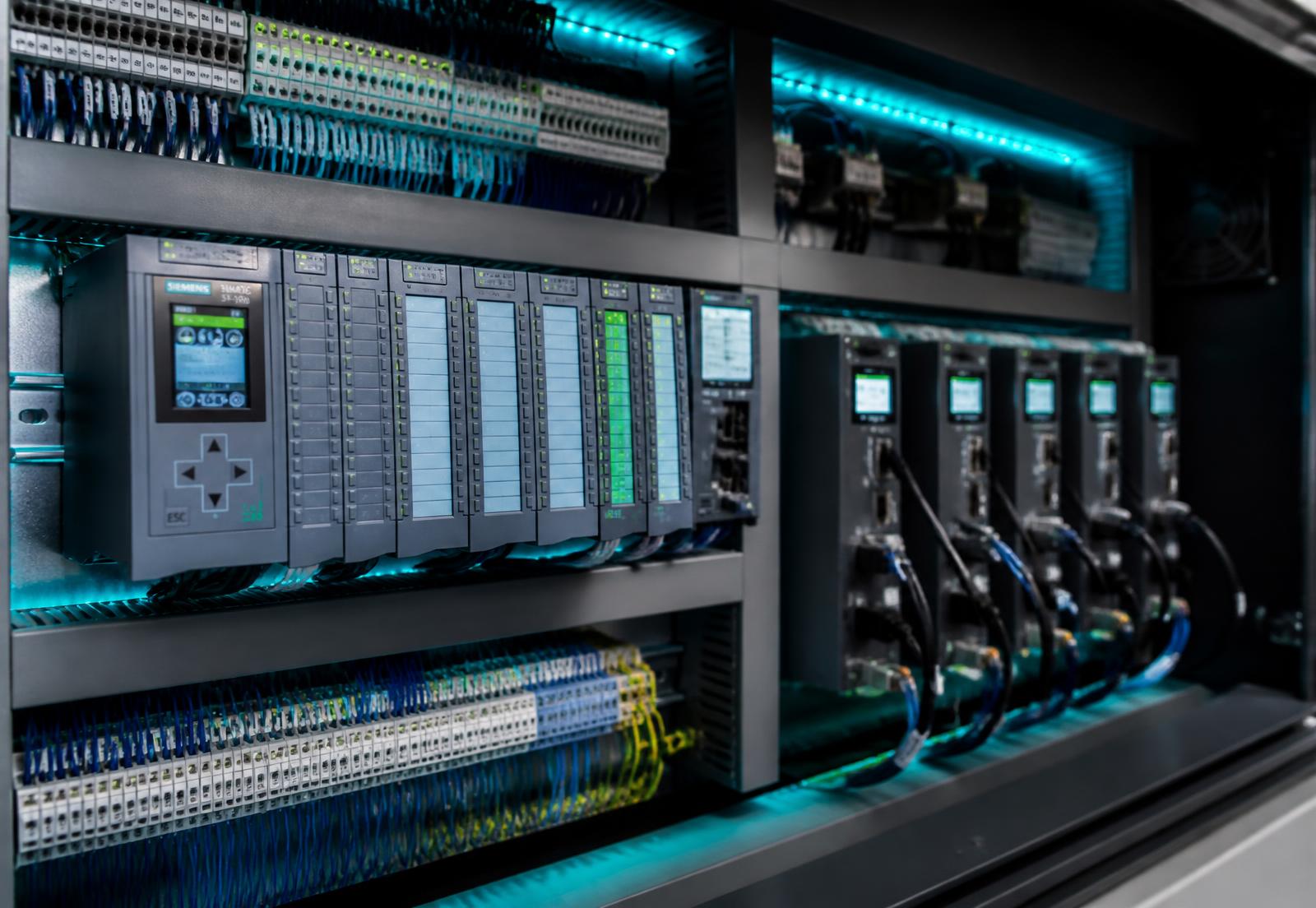 Industrial automation control cabinet with PLC modules and servo drives